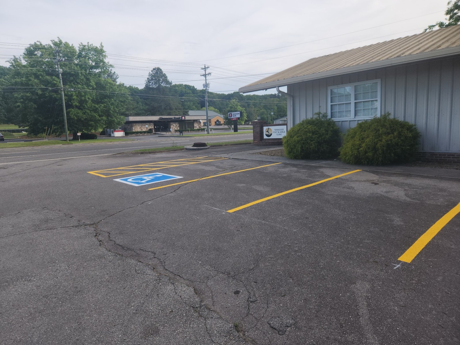 Completed yellow ADA parking lines beside building